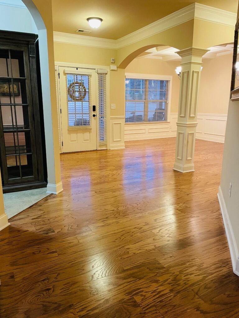 Natural oak floor in an open entry with arched openings