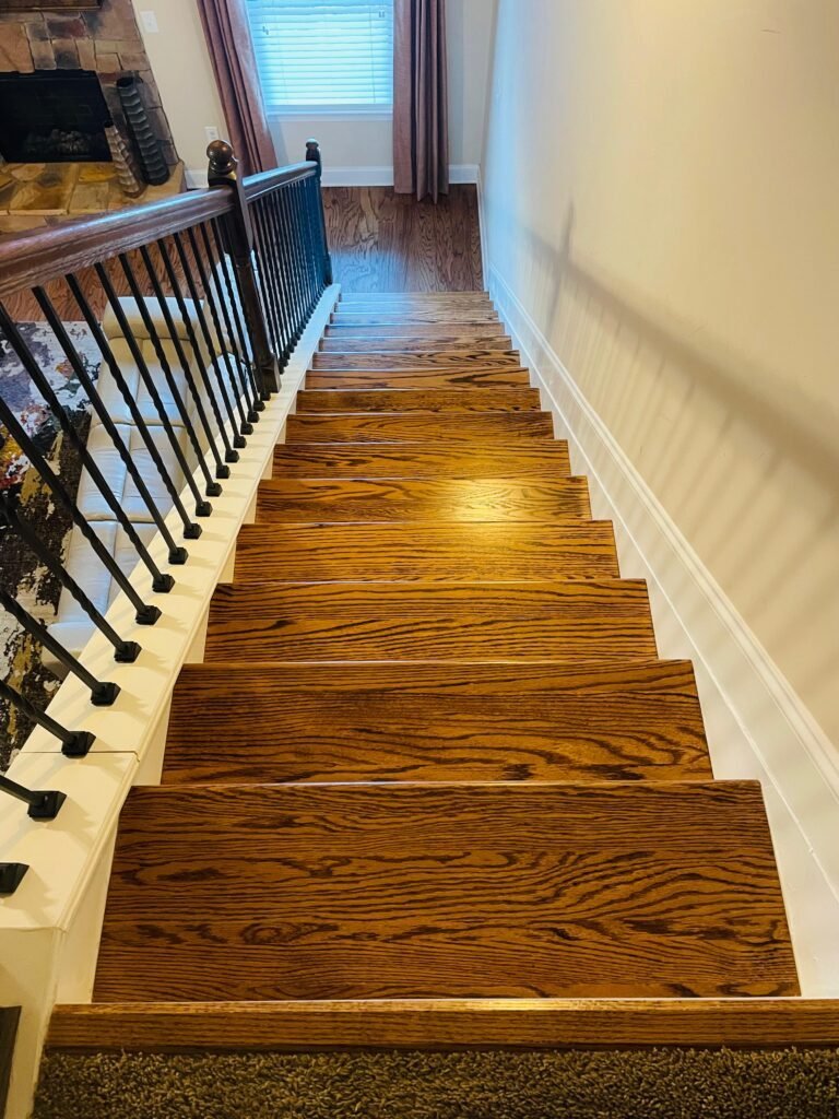 Oak stair treads with iron balusters and white wall trim