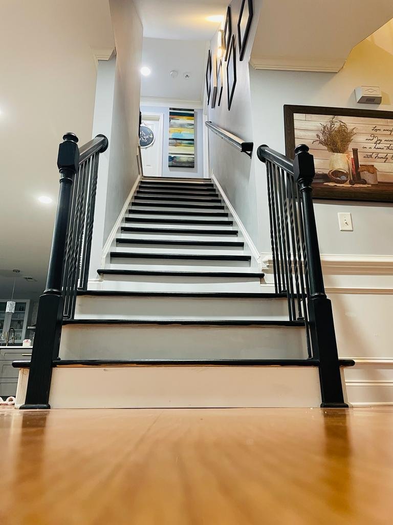 Staircase with dark treads and white risers seen from the landing