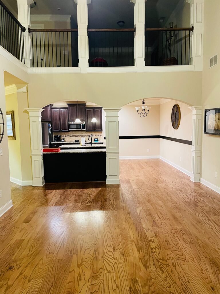 Open two story living area with a wide oak hardwood floor